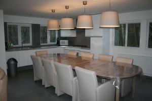 a kitchen with a large wooden table and chairs at Chalet Jarte in Barvaux