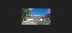 a view of a patio with umbrellas and stairs at bahia montecarlo in Les Cases d'Alcanar