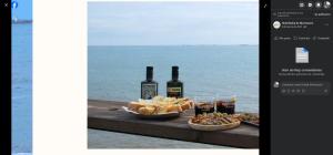 a table with food and bottles of wine and drinks at bahia montecarlo in Les Cases d'Alcanar