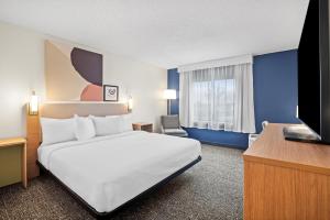 a hotel room with a bed and a television at Spark by Hilton Bettendorf Quad Cities in Bettendorf +24 photos