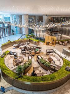 a large lobby with couches and tables in a building at Hilton Chengdu in Chengdu