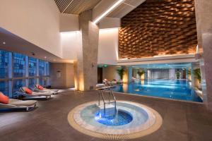 a swimming pool in a building with a hotel at Hilton Chengdu in Chengdu