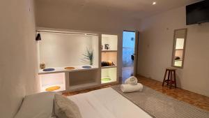a bedroom with a white bed and a large window at CasaMarena in Isla Mujeres