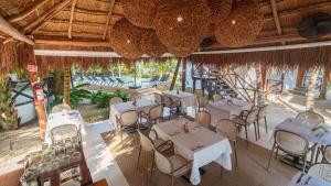 an overhead view of a restaurant with tables and chairs at Azulea Bacalar Hotel & Spa - Lagoon Front in Bacalar