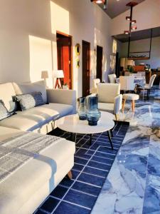 a living room with a couch and tables at Villa Palladio Carrillo in Hojancha