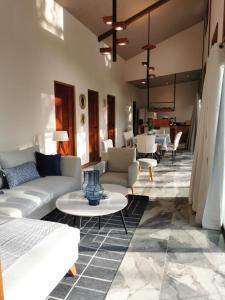 a living room with couches and tables at Villa Palladio Carrillo in Hojancha +16 photos