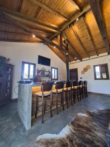 a room with a bar with chairs and a table at Cabana Morro das Pedras in Armazém