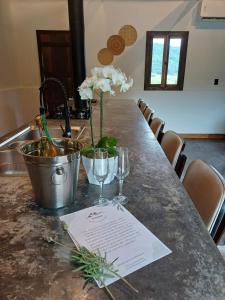 a table with wine glasses and flowers on a counter at Cabana Morro das Pedras in Armazém