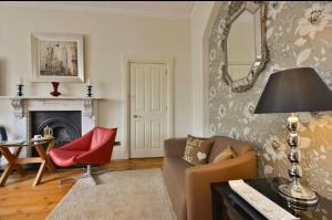 a living room with a couch and a chair at Taunton House Hotel in Taunton