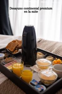 a tray of breakfast foods and a vase on a table at Awwa Suites & Spa in Buenos Aires