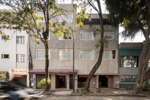 a building with trees in front of it at Hotel Oculto in Mexico City