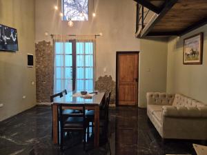 a living room with a table and a couch at Manipa Loft 2 in Cafayate +5 photos
