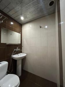 a bathroom with a toilet and a sink at Payl Hotel in Arrinj +22 photos