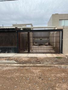 an iron gate in front of a building at Rincón del Agreste in Neuquén