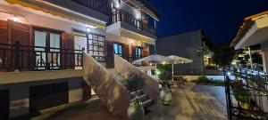 a balcony of a house at night at Iris House in Ierissos