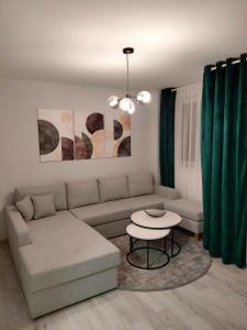 a living room with a couch and a table at Apartment 10 in Inđija