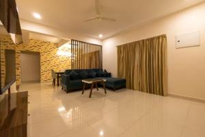 a living room with a couch and a table at 4 BHK villa with private Jacuzzi & Shared pool- Anjuna in Anjuna