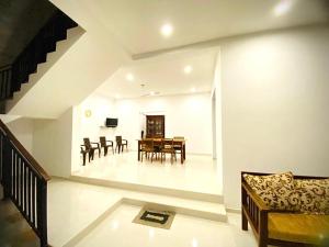 a dining room and living room with a table and chairs at Emerald Sea Breeze - Madiha in Nikawatawana