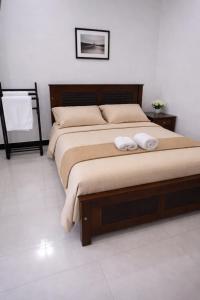 a bedroom with a bed with two towels on it at Emerald Sea Breeze - Madiha in Nikawatawana