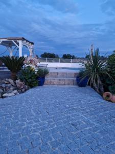 a stone walkway with plants and a gazebo at Casa Brens in Brens