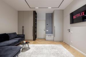 a living room with a couch and a table at Renest Milano Elegance Stay in Chişinău