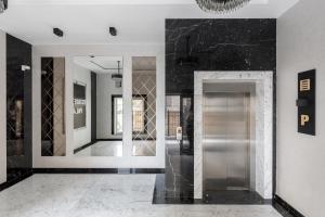 a lobby with a silver elevator in a building at Renest Milano Elegance Stay in Chişinău