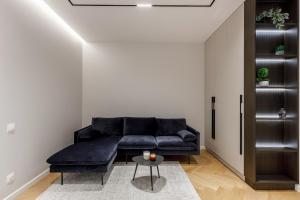 a living room with a black couch and a table at Renest Milano Elegance Stay in Chişinău +28 photos