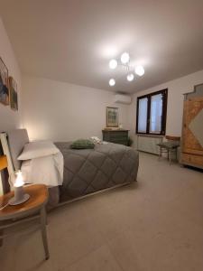 a bedroom with a bed and a table and a window at Podere Radici - Room & Breakfast in Misano Adriatico