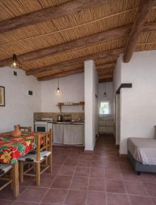 a living room with a table and a kitchen at El Sueñero in Tilcara