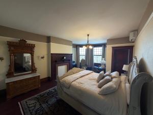 a bedroom with a large bed and a mirror at Alden Villa in Lebanon