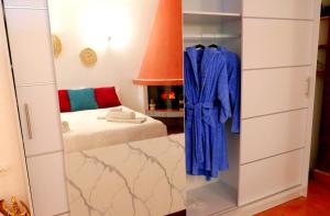 a dressing room with blue robes and a bed at The Lodge apartment in Mesongi +25 photos