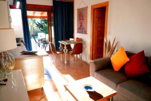 a living room with a couch and a table at The Lodge apartment in Mesongi