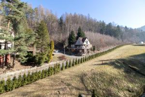 a house on the side of a hill with trees at Kurort Kozubnik Daglezja D23 Vista Stay in Porąbka