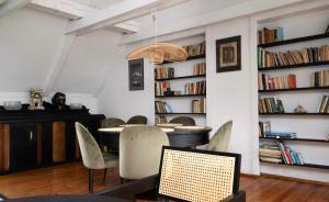a dining room with a table and chairs and bookshelves at Unique House with private swimming pool by the sea - AFRA GROUP in Sopot