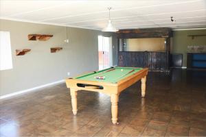 a room with a pool table in a room at Little Waters Bnb in Queenstown