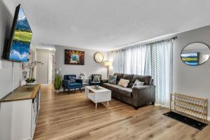 a living room with a couch and a table at New 3BDRM Centrally Located Free Parking AC in Buffalo