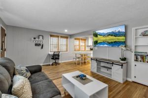 a living room with a couch and a flat screen tv at New 3BDRM Centrally Located Free Parking AC in Buffalo