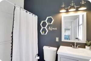 a bathroom with a toilet and a sink and a mirror at Simply Adventurous in Mexico Beach +11 photos