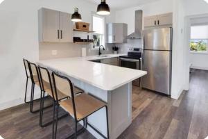 a kitchen with a white counter and a refrigerator at Simply Adventurous in Mexico Beach
