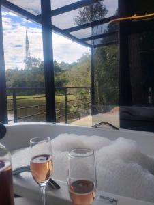 two glasses of wine sitting on top of a bath tub at Verde Vale in Nova Petrópolis