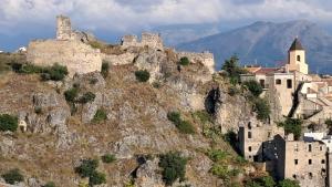 a castle on the side of a mountain at levante rooms in Scalea