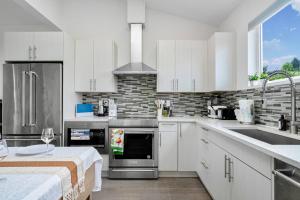 a kitchen with white cabinets and stainless steel appliances at 3BR Queen Anne House with Rooftop access in Seattle