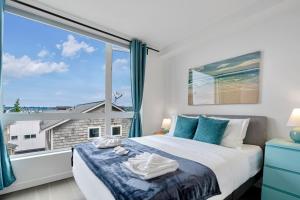 a bedroom with a bed and a large window at 3BR Queen Anne House with Rooftop access in Seattle
