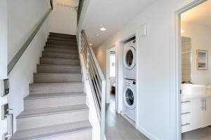 a laundry room with stairs and a washer and dryer at 3BR Queen Anne House with Rooftop access in Seattle