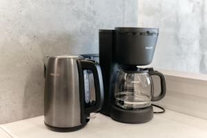 a coffee maker and a coffee pot on a counter at Designer Studio - Rooftop - Sea View - Arcadia 200m in Odesa