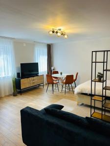 a living room with a bed and a table and chairs at Nicotel in Turda
