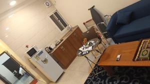 an overhead view of a kitchen with a table and a refrigerator at شقق مساكن الراية المخدومه in Al Khobar