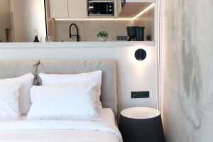 a bedroom with a bed with white pillows at Designer Studio - Rooftop - Sea View - Arcadia 200m in Odesa