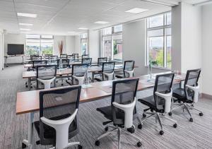 a conference room with tables and chairs and a tv at Element by Marriott Calgary Airport in Calgary