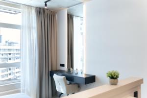 a living room with a chair and a window at Designer Studio - Rooftop - Sea View - Arcadia 200m in Odesa +27 photos